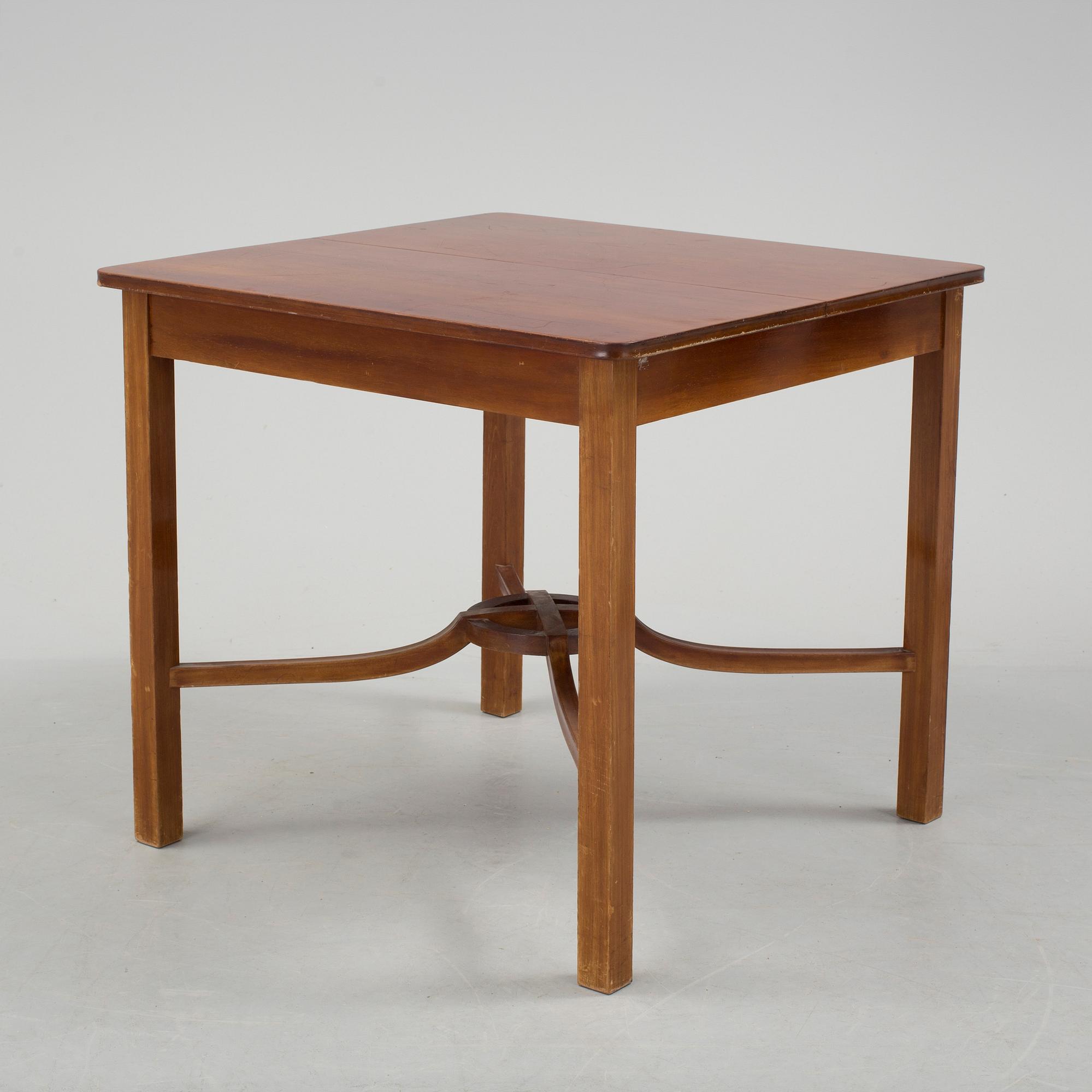 A mid 20th century mahogany veneered table from Nordiska Kompaniet (NK).