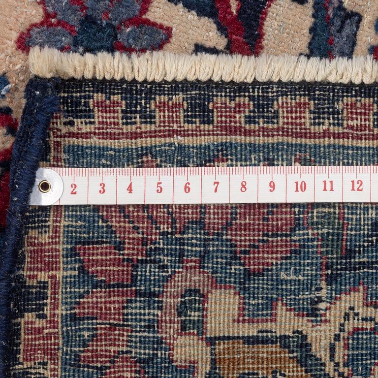 An oriental carpet, approx. 411 x 326 cm.