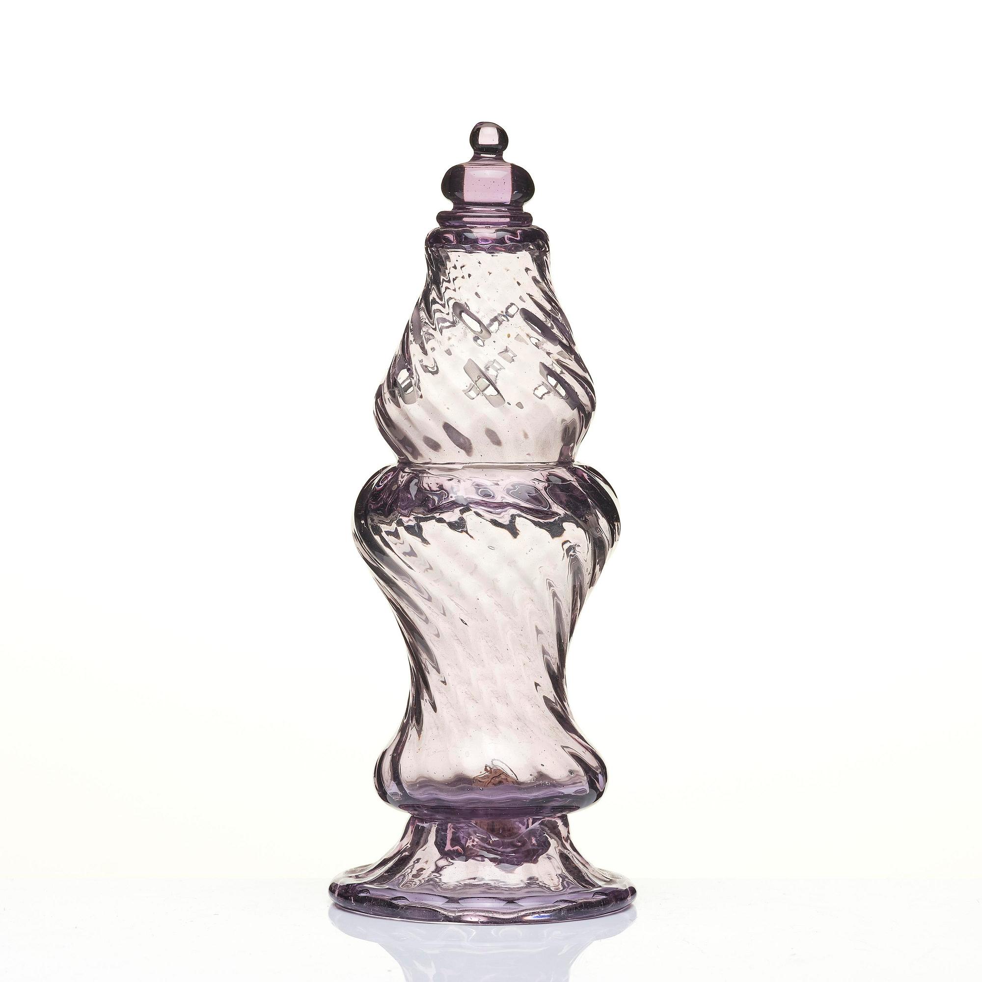 An amethyst coloured suger shaker and a cut glass goblet, 18th century.