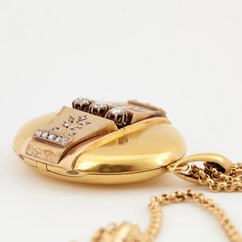 An 18K gold locket set with rose-cut diamonds.