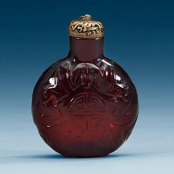 1448. A large red sculptured peking glass snuff bottle with stopper, presumably around 1900.