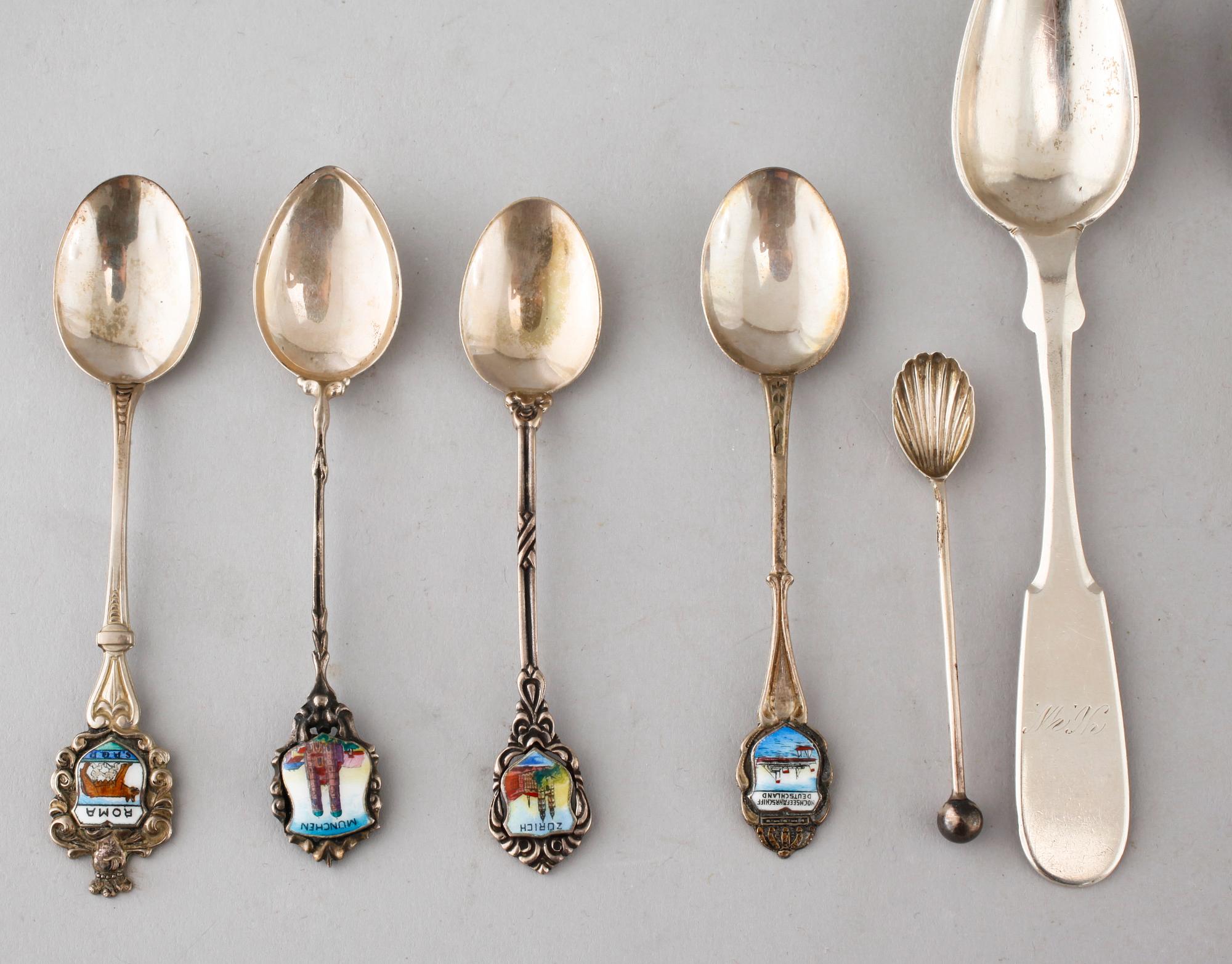 A collection of silver of 57 pcs, i.a souvenir spoons, 20th century. Total weight 1073 g.