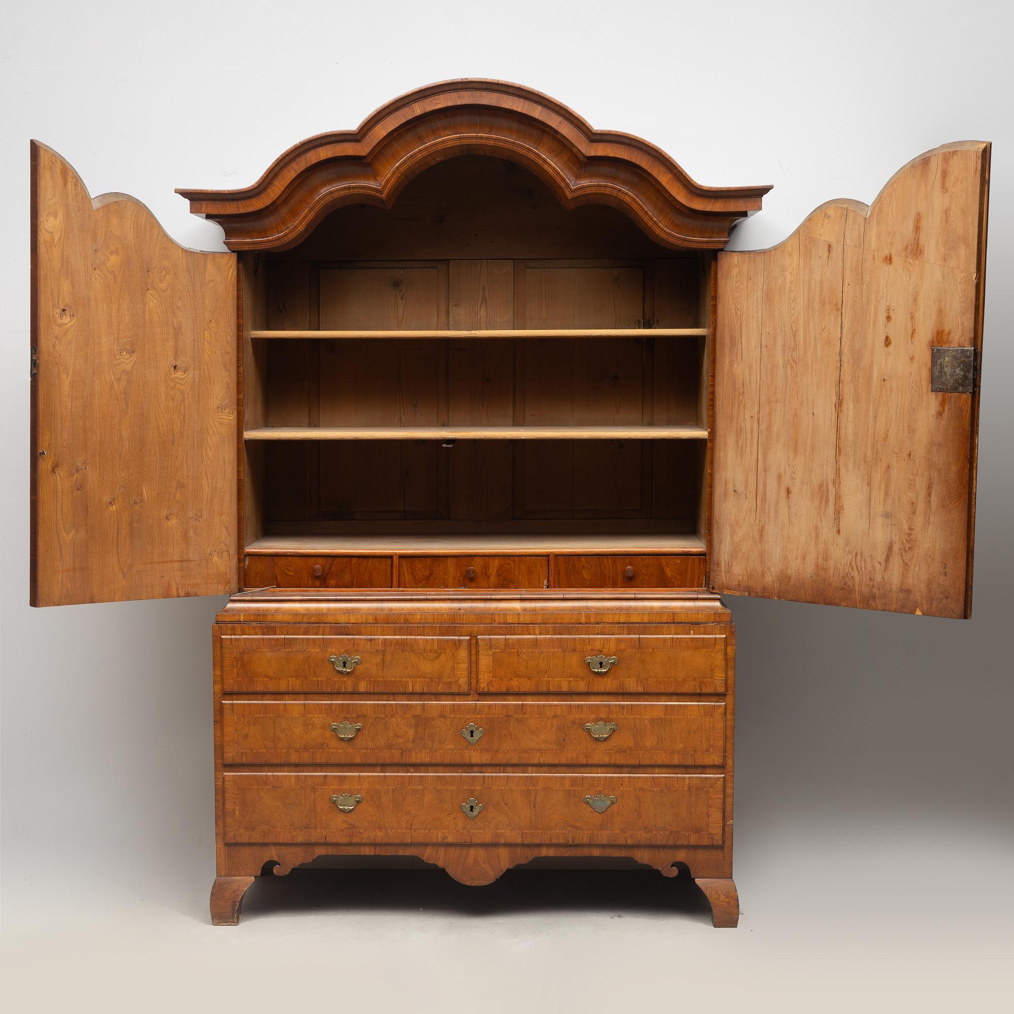 A late Baroque walnut-veneered cabinet in the manner of J. H. Fürloh, mid 18th century.