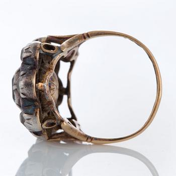 A ring set with an emerald and old-cut diamonds.