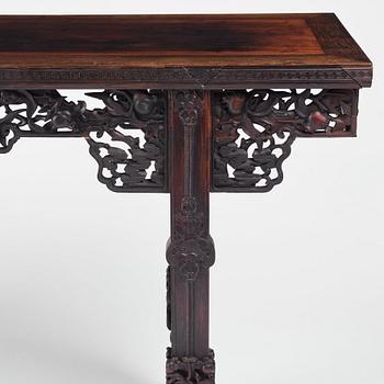 A massive zitan recessed-leg long table 'Jiaotousun Qiotouan', Qing dynasty, 19th century.