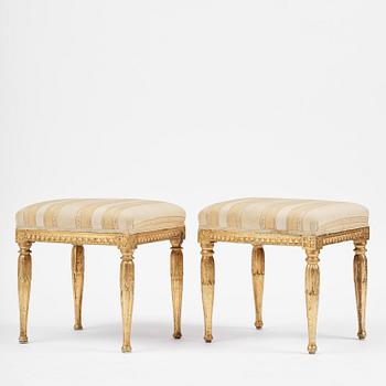 A near pair of late Gustavian giltwood stools, one by J. Hammarström (master in Stockholm 1794-1812).