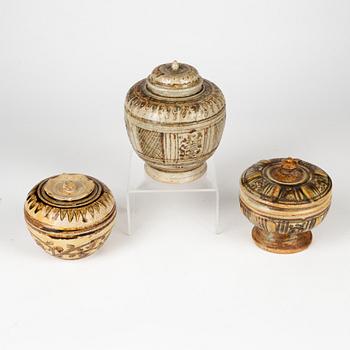 A group of three brown Sawankhalok jars with covers, Thailand, 14th/17th Century.