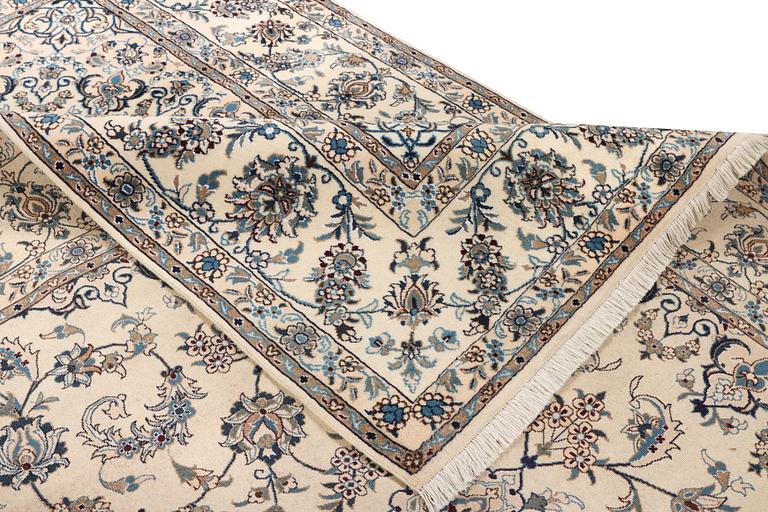 A Nain, part silk carpet, c. 337 x 244 cm.