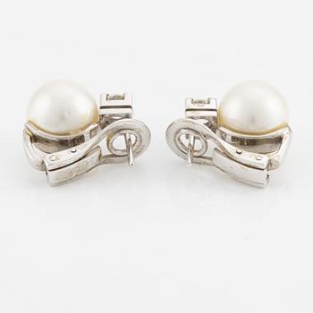 A pair of pearl and diamond earrings.