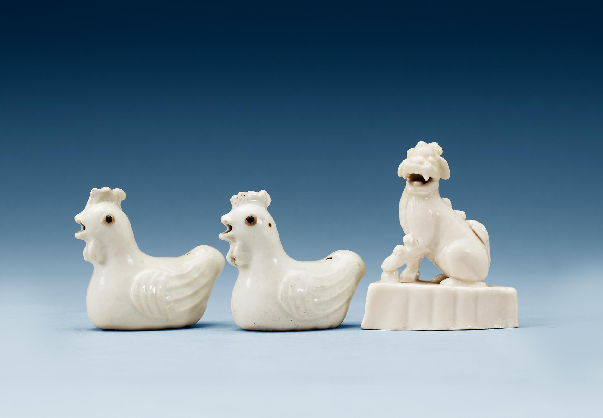 A pair of blanc de chine water droppers and a figure of a 'Buddhist Lion', Qing dynasty, Kangxi (1662-1722).