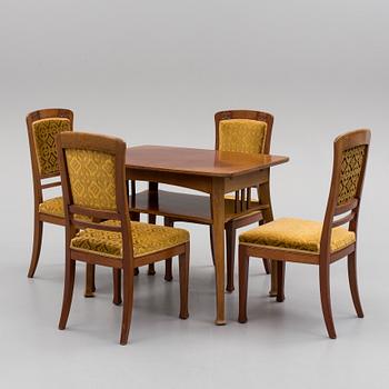 An early 20th century table with 4 chairs.