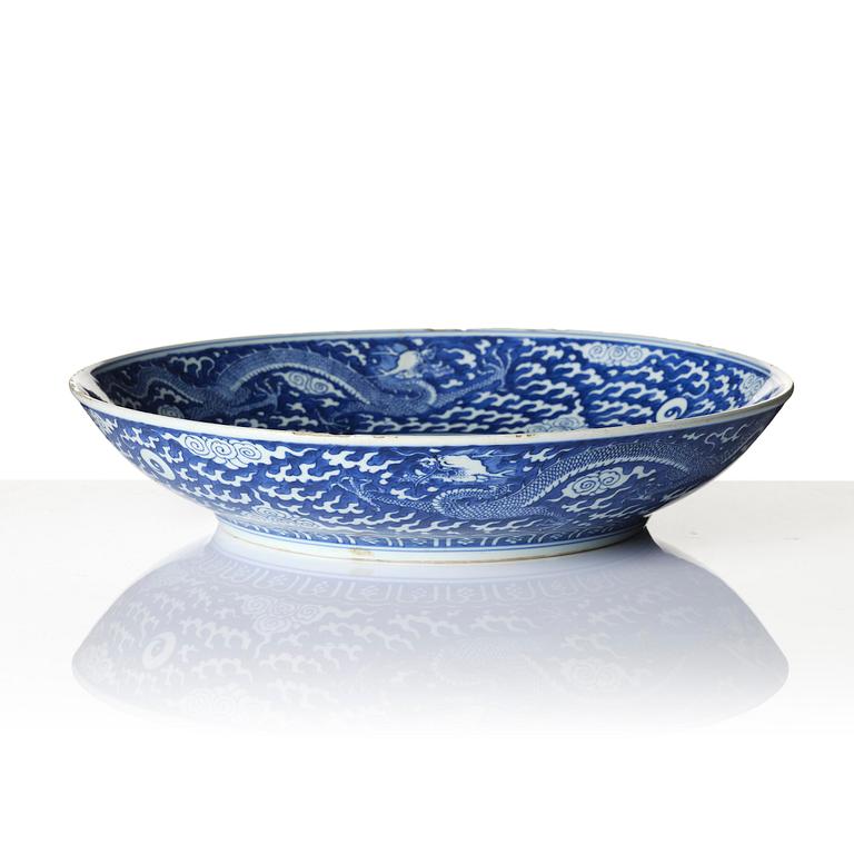 A rare large blue and white 'five clawed dragon' dish, Qing dynasty with Kangxi mark and of the preriod (1662-1722).