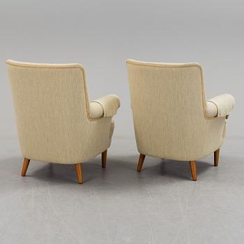 A pair of second half of the 20th century 'Hemmakväll' easy chairs by Carl Malmsten.