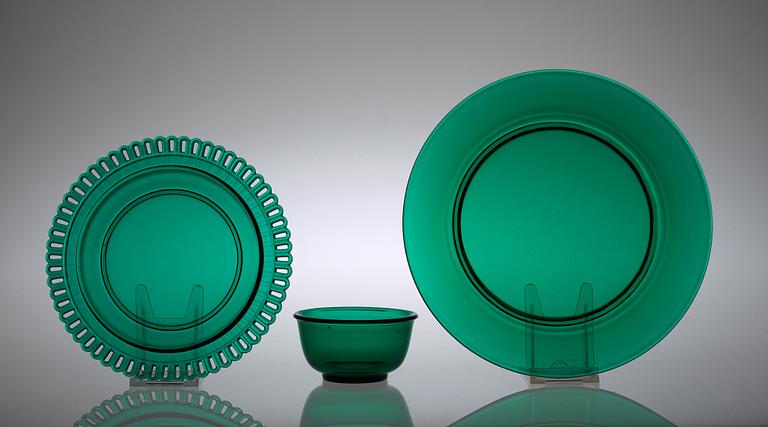 An Estrid Ericson set of 12 + 12 green glass plates and a bowl, Svenskt Tenn.