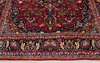 A carpet Mashad, signed, around 290 x 245 cm.