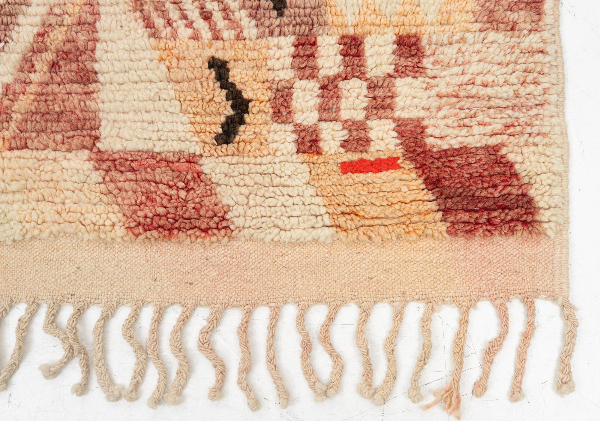 A Moroccan crpet, c. 240 (+7+8 cm flat weave) x 151 cm.