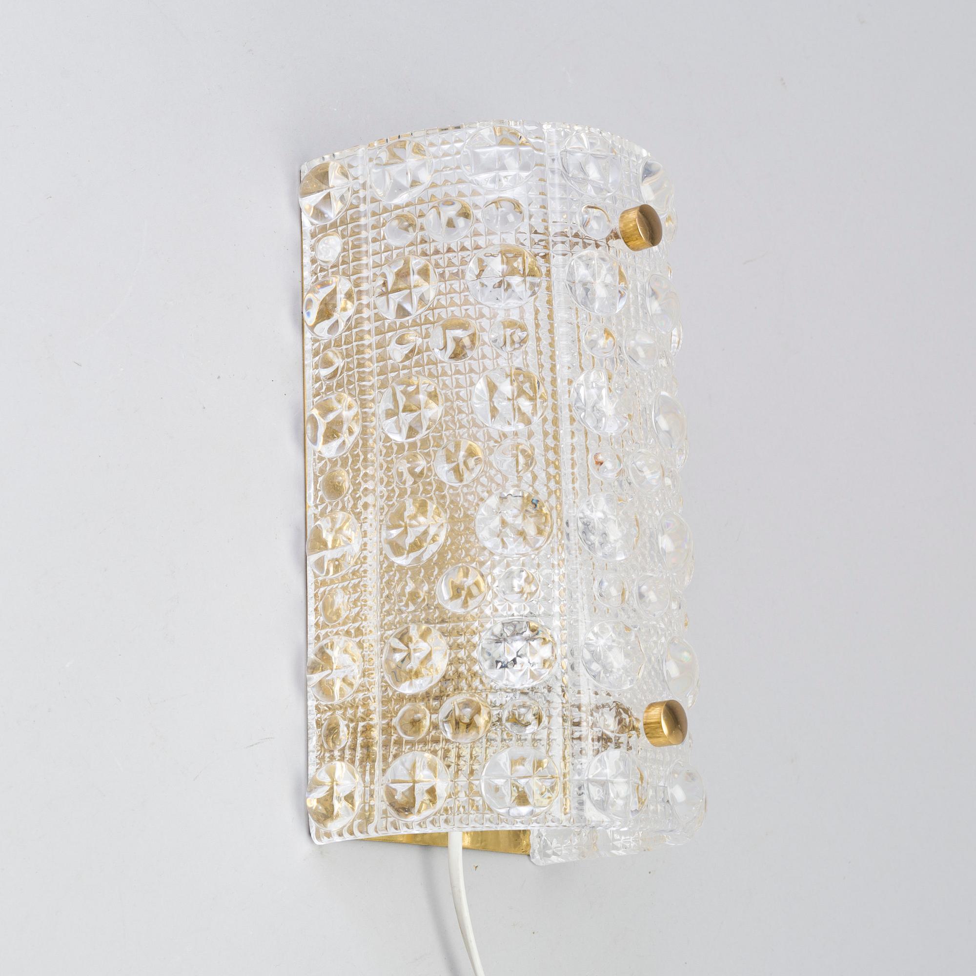 CARL FAGERLUND, a brass and glass Orrefors wall light, and a pait of wall lamps, unknown designer, 1960/70s.