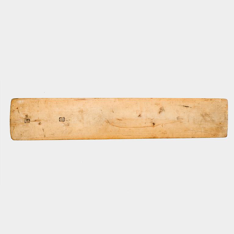 A Swedish folk art mangle board with carved decorationd, owners' initials and the date 1744.