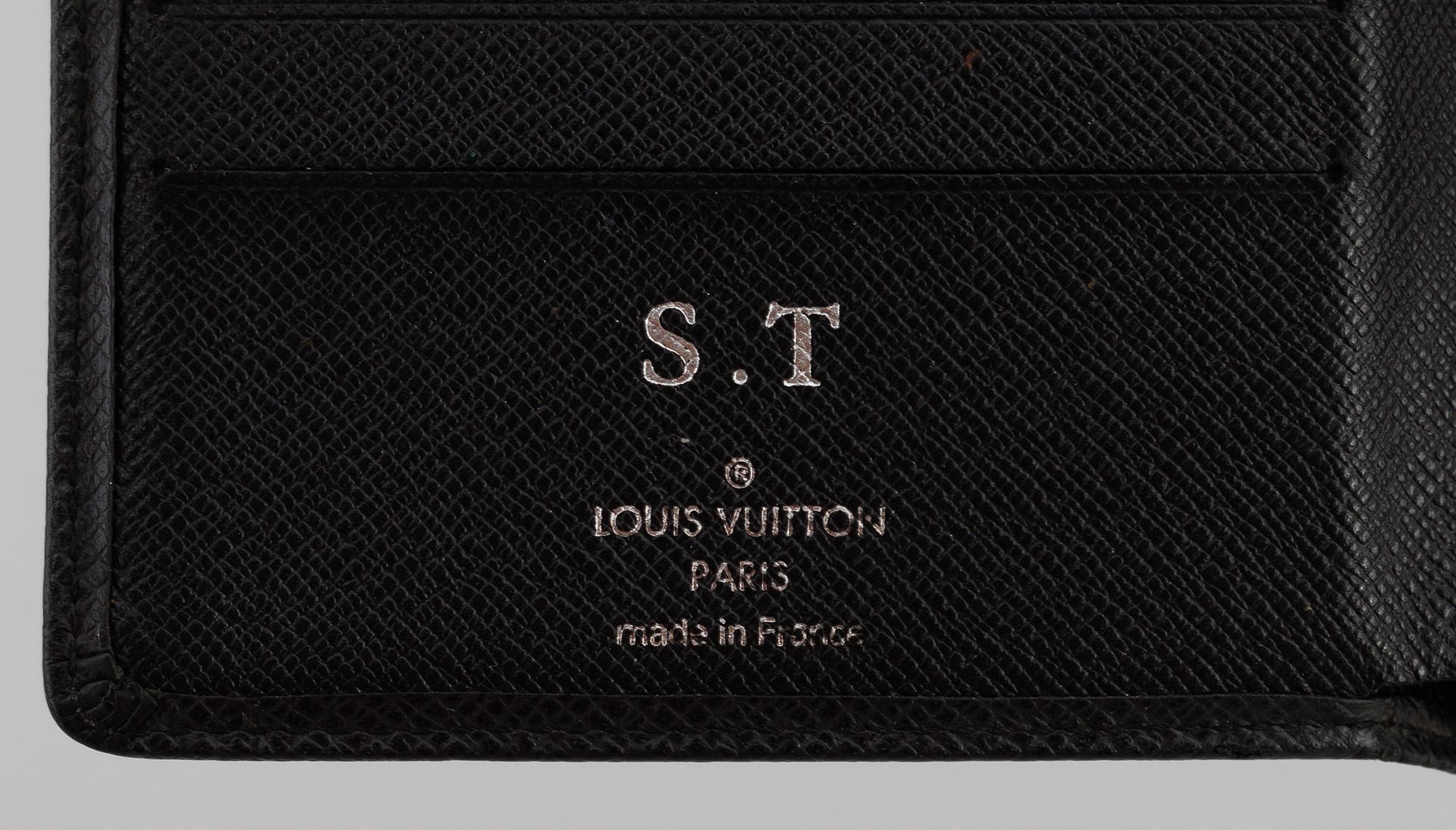 LOUIS VUITTON, black taiga leather wallet.