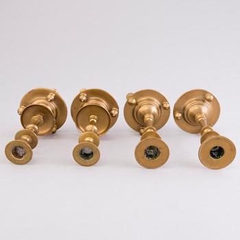 Four Russian brass candlesticks, two marked Pimenov, around 1900.