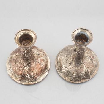 A pair of Chinese silver plated copper candle sticks, 20th century.