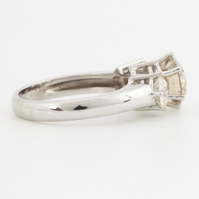 Fancy light yellowish brown round brilliant-cut diamond ring.