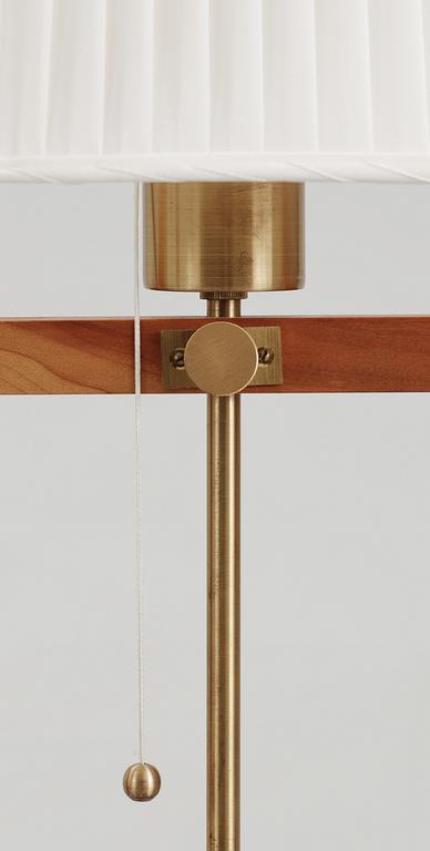 A pair of Josef Frank walnut and brass floor lamp by Svenskt Tenn, model 2548.