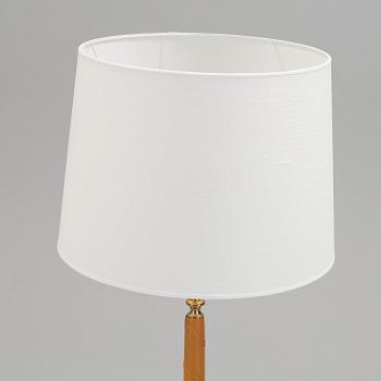A 1960s brass and leather floor light.