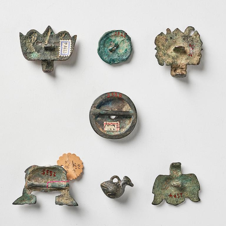 A set of seven bronze ornaments, archaic, presumably Zhou/Han dynasty.