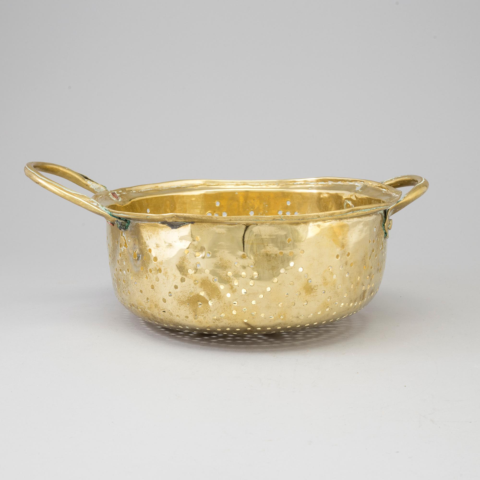 A 19th century brass colander.
