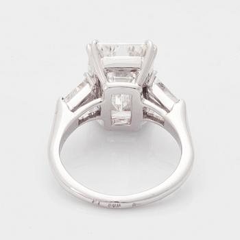 A platinum ring set with an emerald-cut diamond.