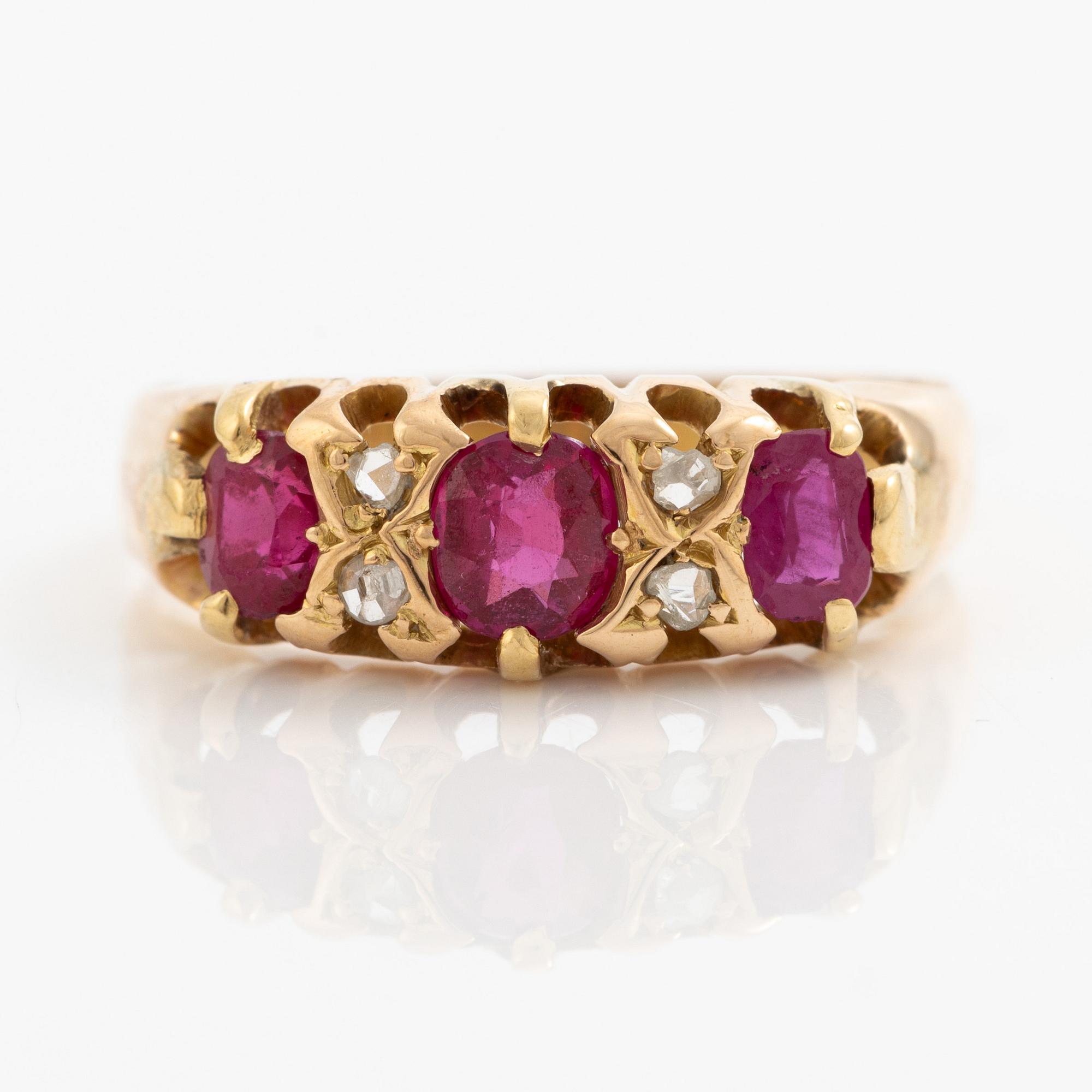 A ring 18K gold with rose-cut diamonds and red stones.