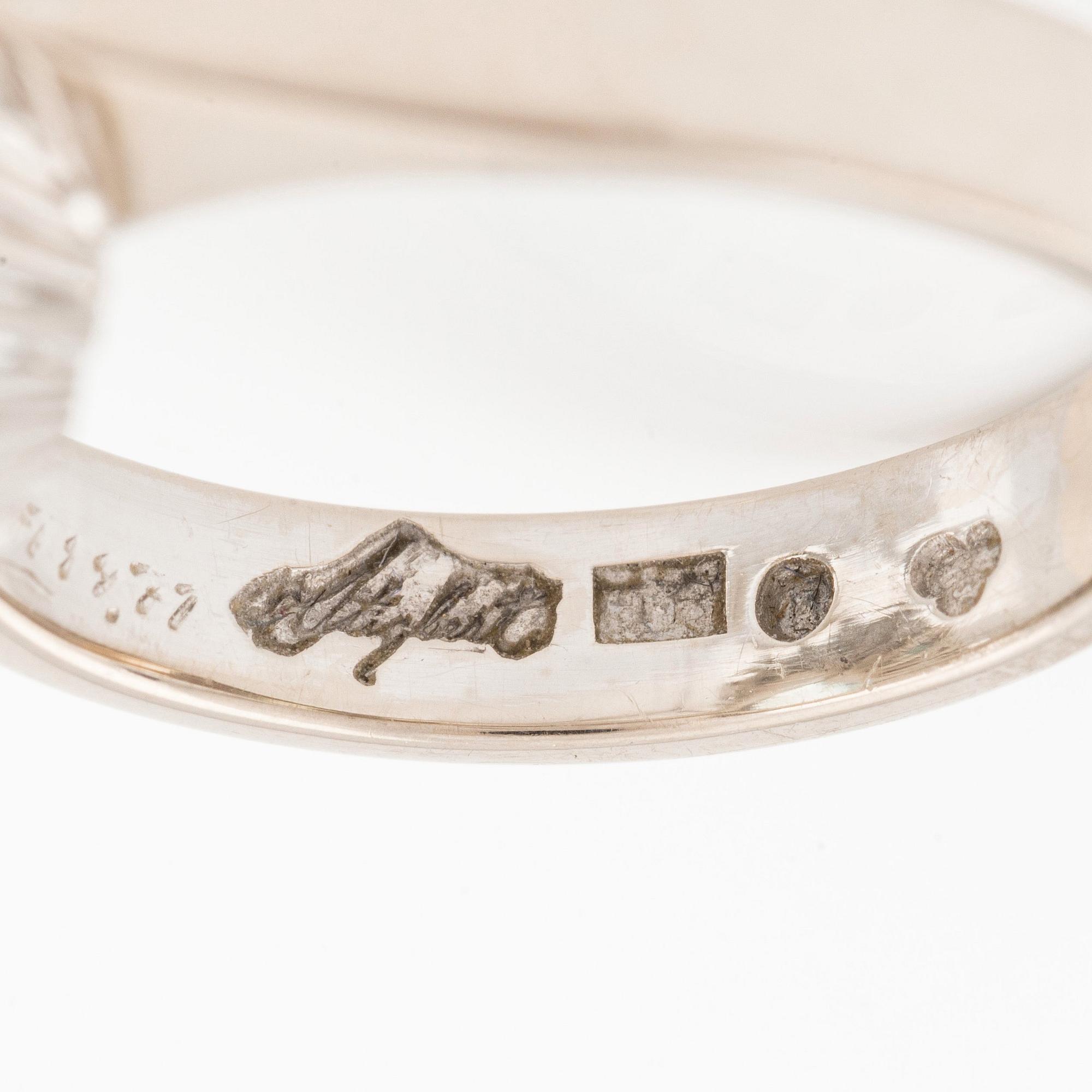 An 18K white gold Engelbert ring set with a aquamarine and round brilliant-cut diamonds.