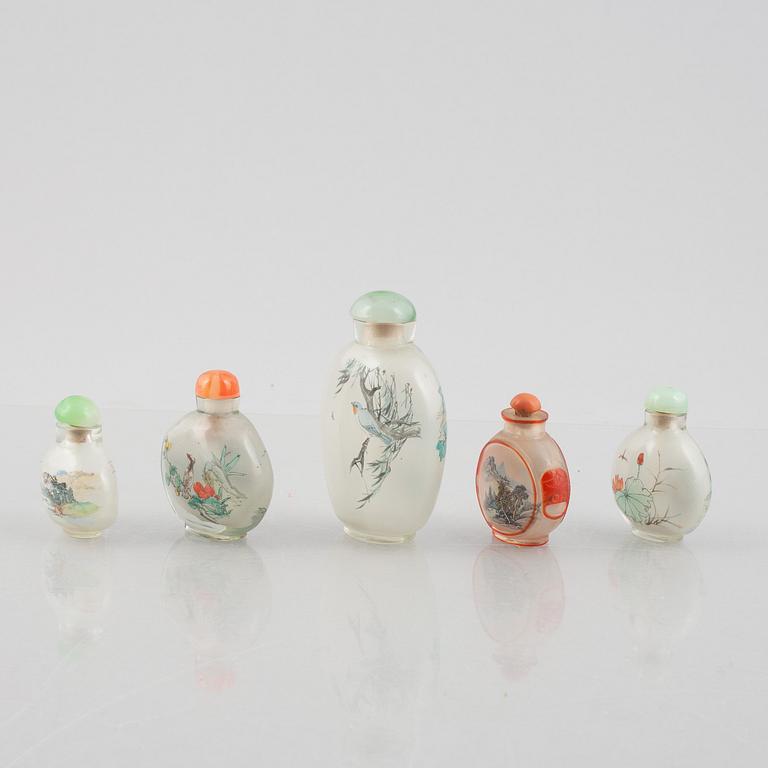 A group of nine Chinese glass and porcelain snuffbottles, 20th century.