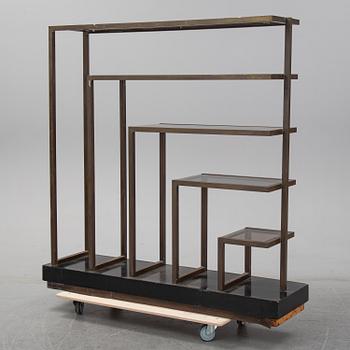 A metall and glass bookcase, late 20th Century.