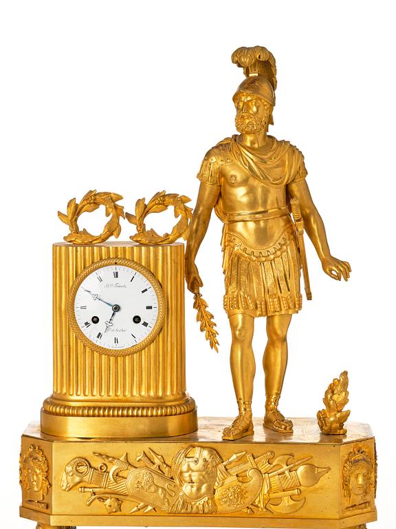 An Empire mantel clock, first part of the 19th century .