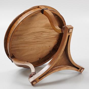 A mahogany veneered Empire style table, first half the 20th Century.