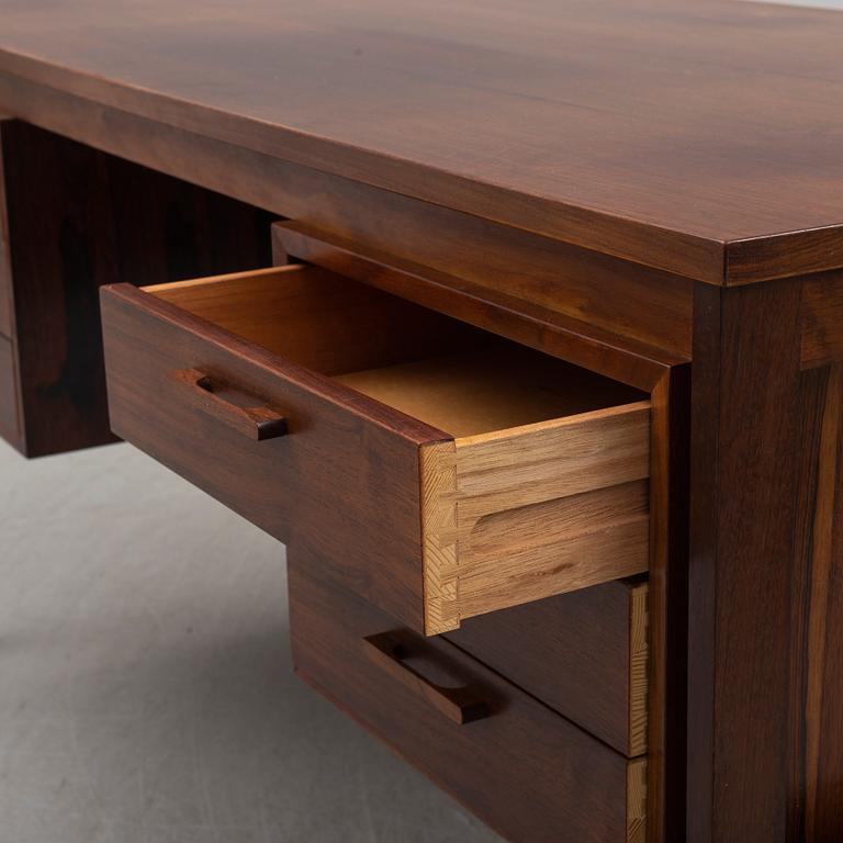 A 1960's/1970's rosewood veneered desk.