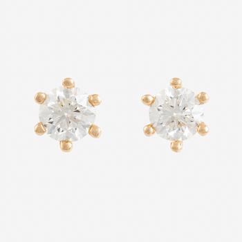 A pair of gold earrings set with round brilliant-cut diamonds.