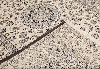 A Nain, part silk carpet, 305 x 207 cm.