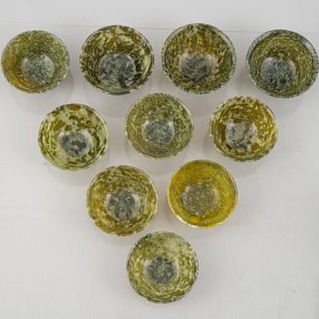 A group of ten Chinese spinach green stone bowls.