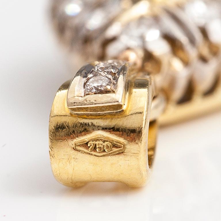 An 18K gold penadant with brilliant cut diamonds ca. 1.45 ct in total and a sapphire.