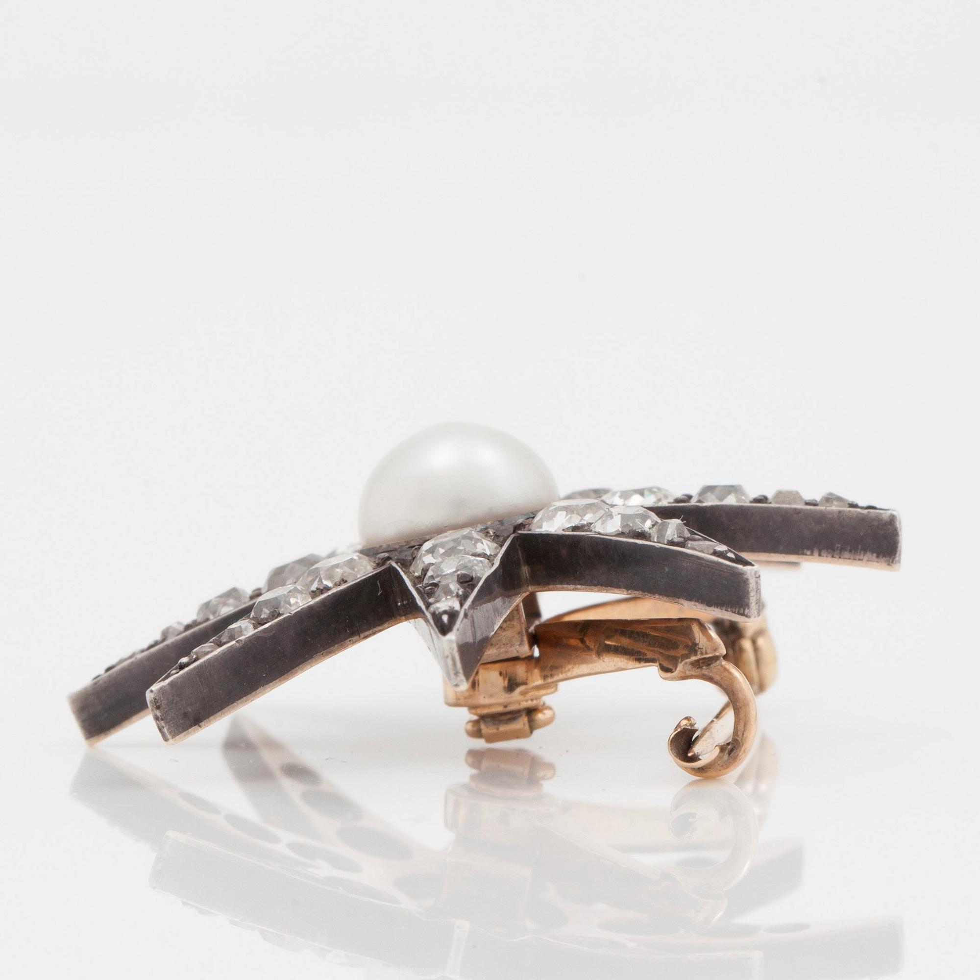 A late Victorian old cut diamond and probably natural pearl brooch in the shape of a star.