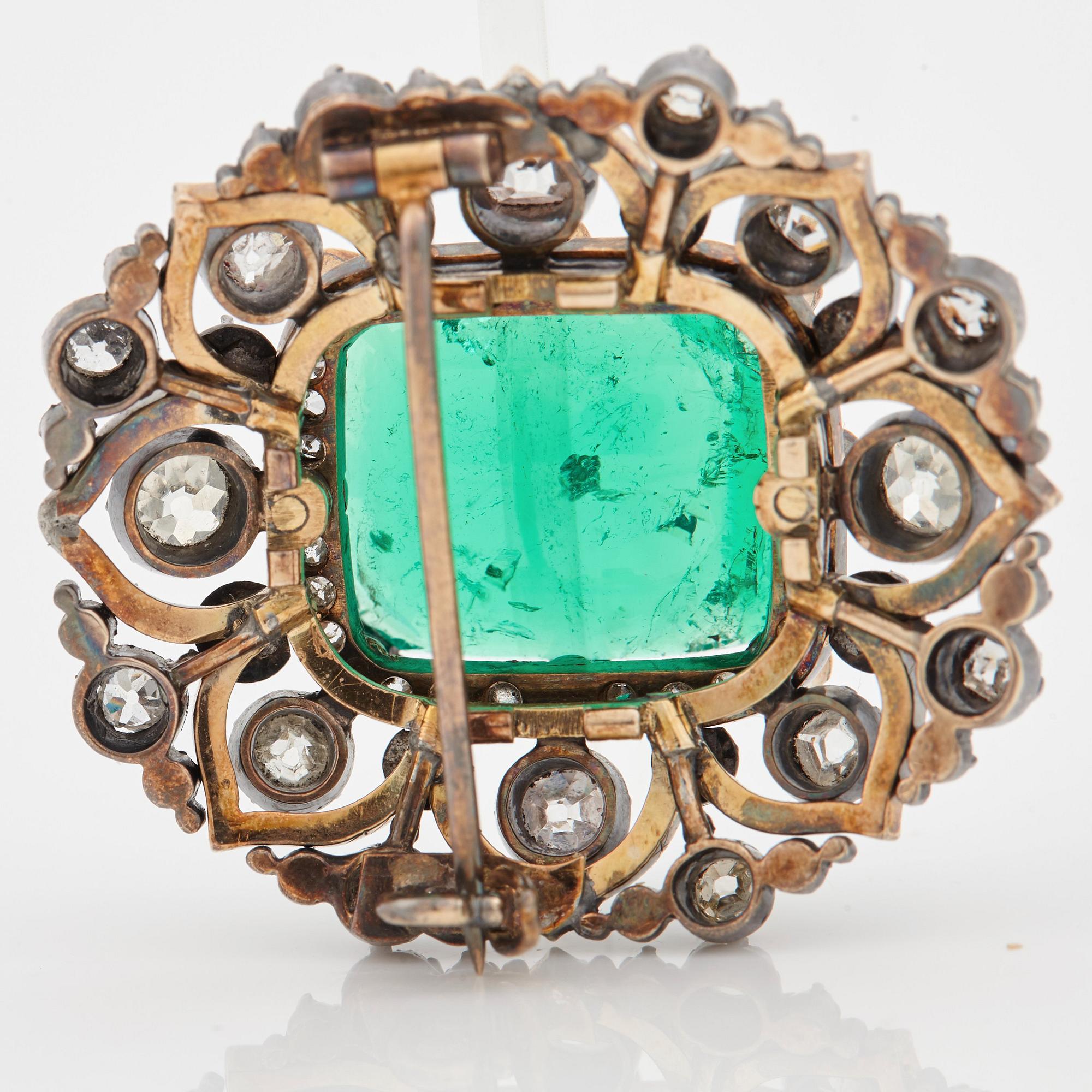 An emerald, black enamel and old cut diamond brooch. 19th century.