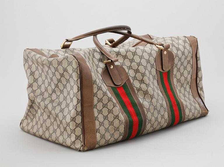 A beige monogram canvas with details in letaher by Gucci.