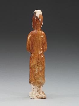 A yellow glazed pottery figure of a court attendant, Sui dynasty (589-618).