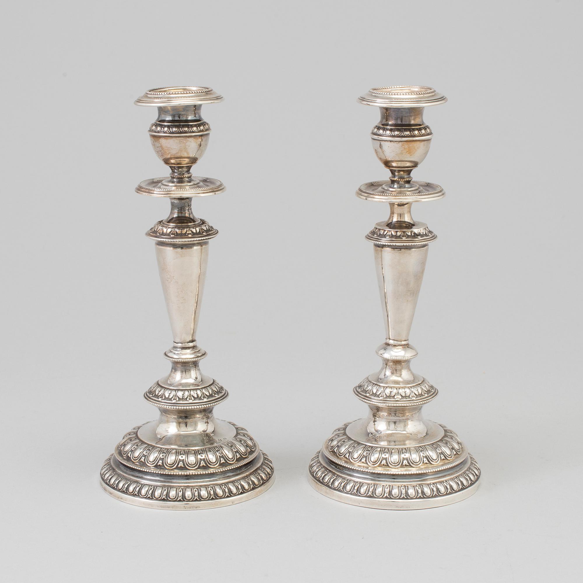 A pair of silver candle sticks, dated 1903.