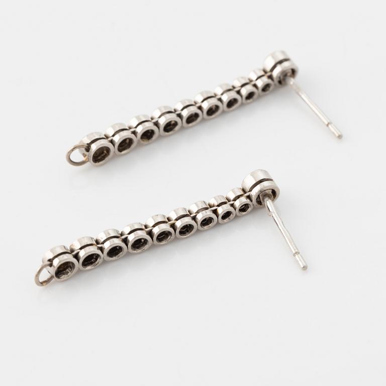 Platinum and brilliant cut diamond line earrings.