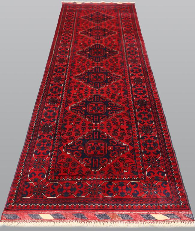 An Afghan runner, approx. 286 x 84 cm.