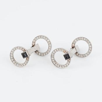 A pair of brilliant-cut diamond and onyx cufflinks.